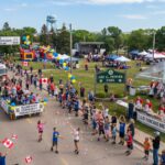 Families enjoying the free pancake breakfast and community parade at the Blumenort Fun and Fair in Blumenort, Manitoba.